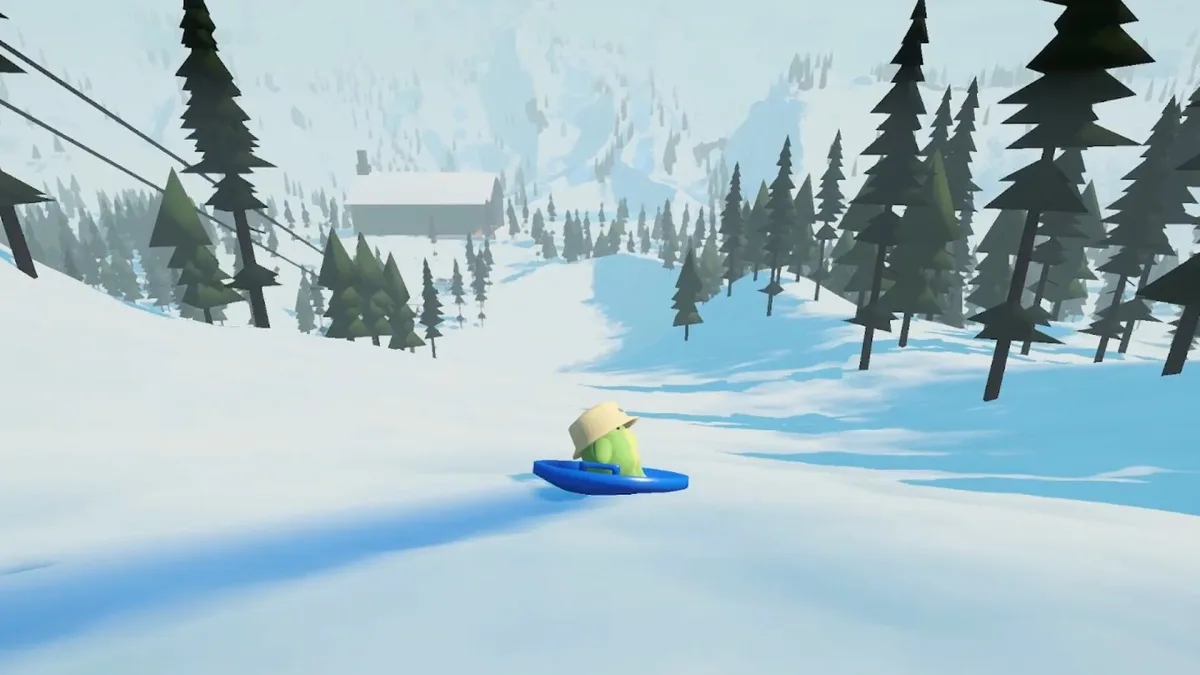 Sledding Game frog riding past snowy trees and cliffs.